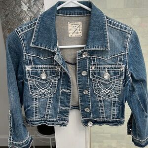 Cropped denim jacket with rhinestone buttons and contrasting white detailing